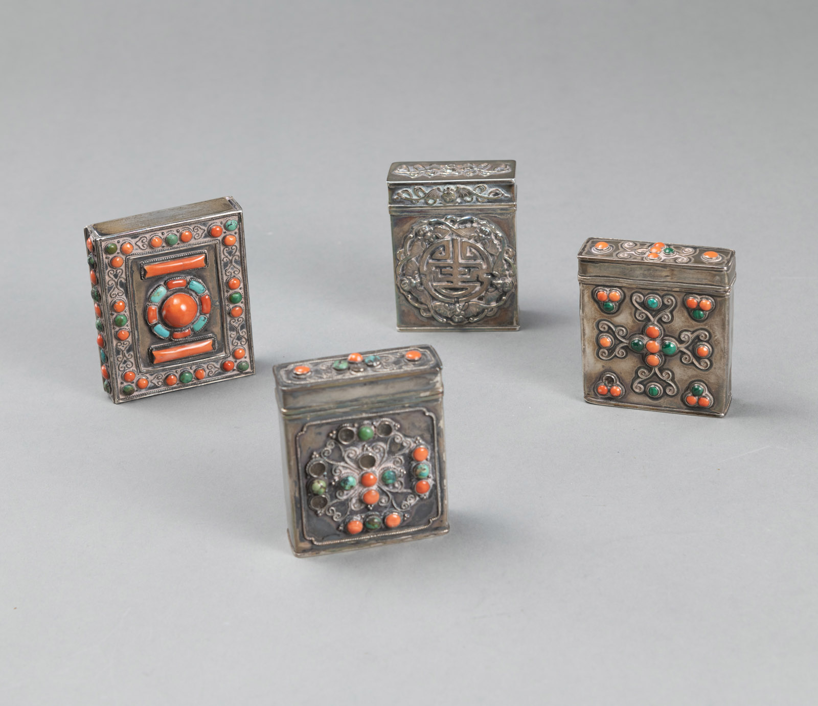 FOUR PARTIALLY CORAL- AND TURQUOISE-INLAID METAL BOXES