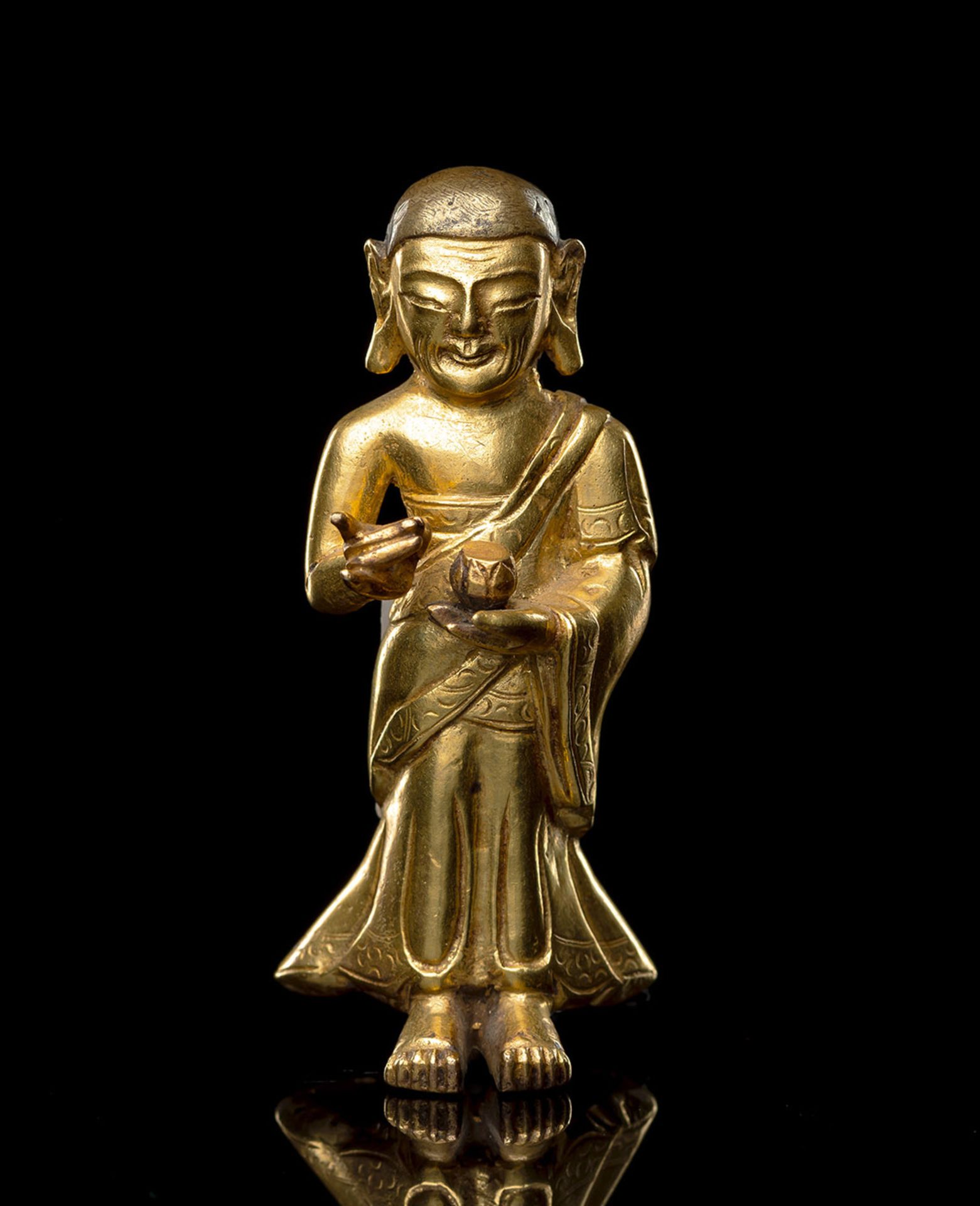 A GILT-BRONZE FIGURE OF PROBABLY SARIPUTRA