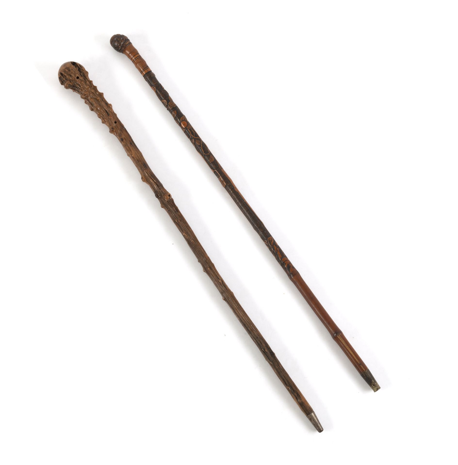 TWO BAMBOO/ROOTWOOD WALKING STICKS ONE WITH CARVED DECORATION OF ASHINAGA