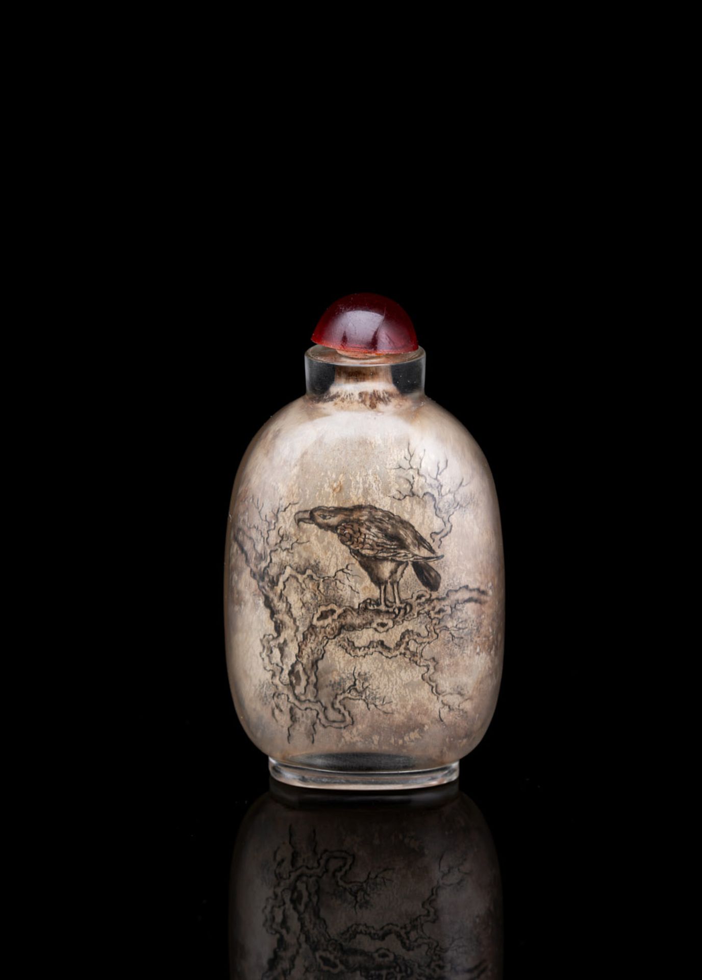 A GRISAILLE REVERSE-PAINTED GLASS SNUFFBOTTLE DEPICTING A BIRD OF PREY ON A TREE BRANCH