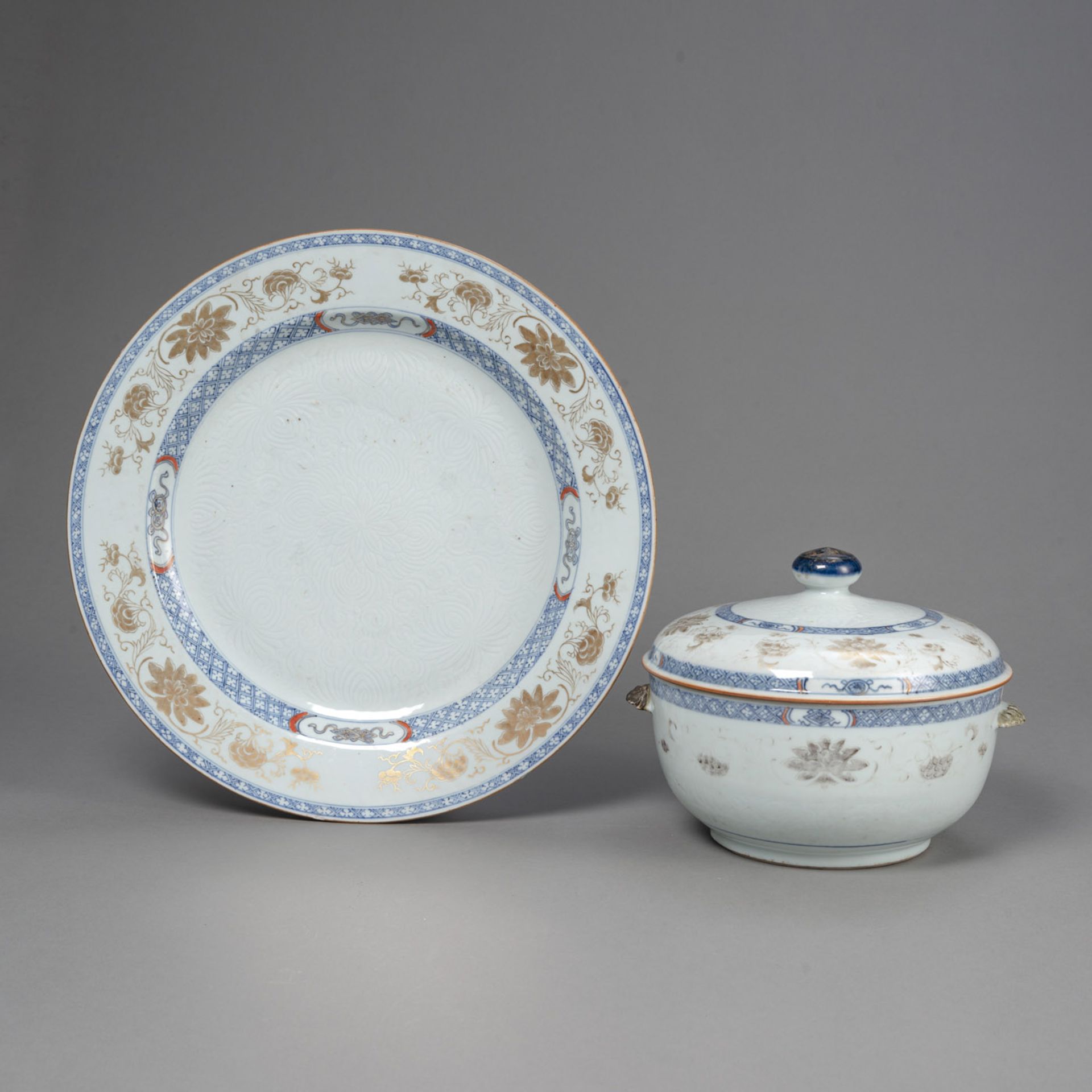 AN UNDERGLAZE BLUE AND GOLD EXPORT PORCELAIN CHARGER WITH CARVED LOTUS AND A TUREEN