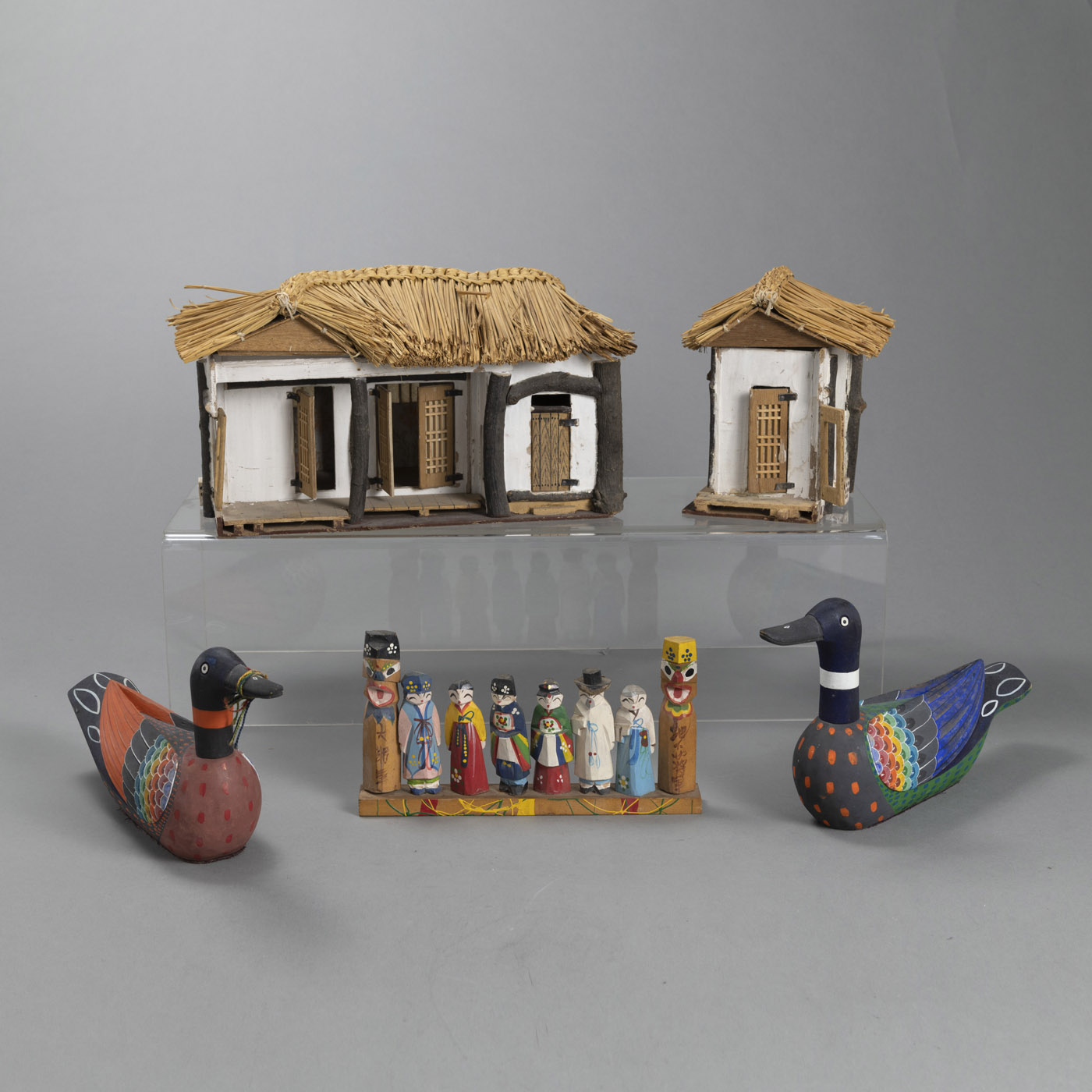 A MODEL OF A YANGBAN HOUSE MADE OF DIFFERENT MATERIALS, A GROUP OF PAINTED WOODEN FIGURES AND A PAI