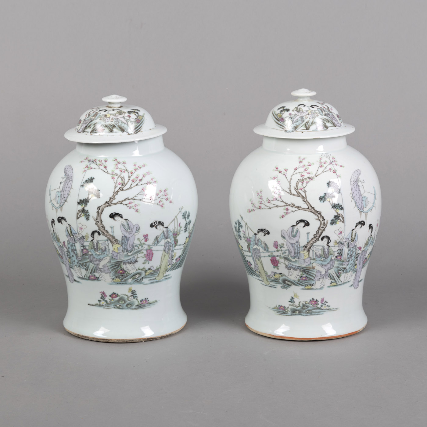 A PAIR OF INSCRIBED 'QIANJIANGCAI' FIGURAL PORCELAIN VASES WITH COVERS