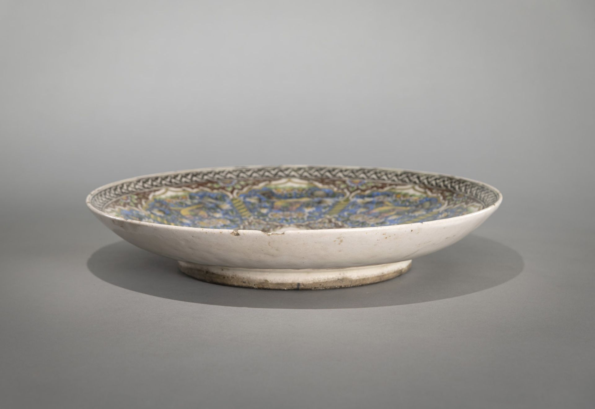 A QAJAR GLAZED POTTERY DISH WITH FINE DECORATION OF FIGURES, ANIMALS AND FLOWERS - Image 3 of 4