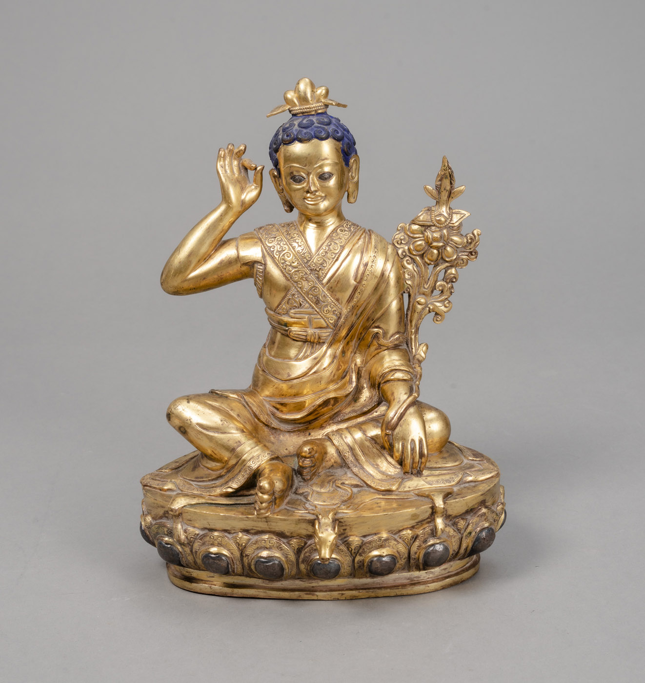 A GILT-BRONZE FIGURE OF MILAREPA