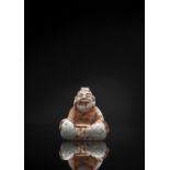 A VERY RARE CALCIFIED JADE FIGURE OF A SEATED MAN