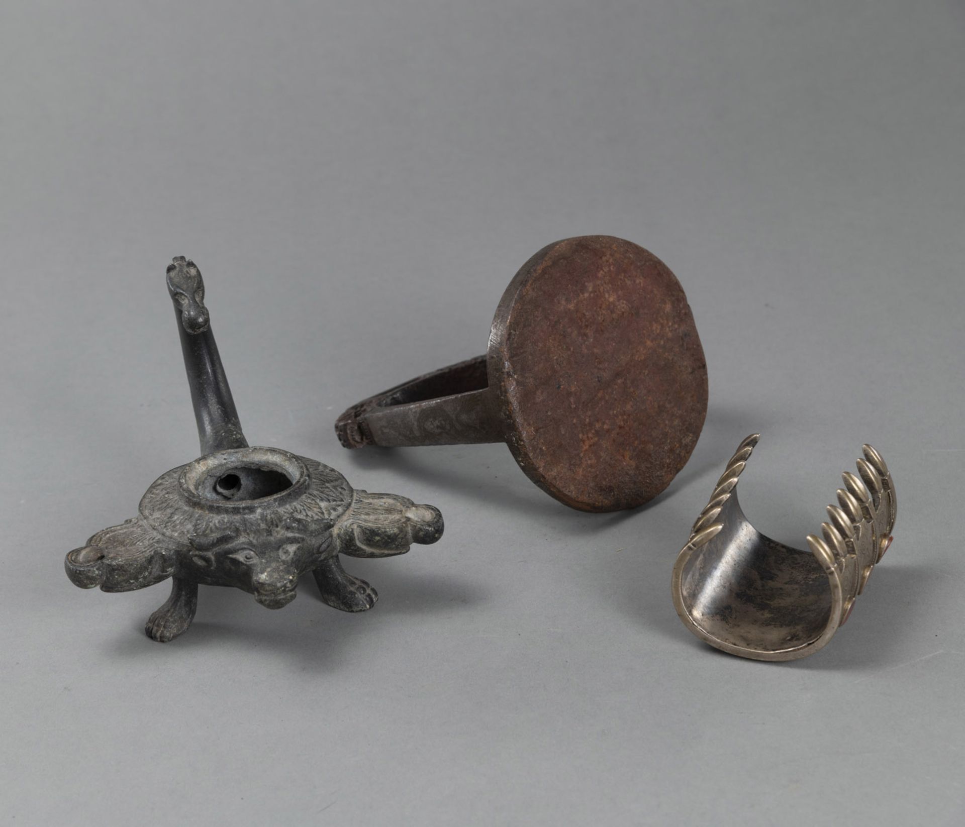 AN IRON STIRRUP, A BRACELET WITH CARNELIAN STONES AND A BRONZE OIL LAMP - Image 3 of 3