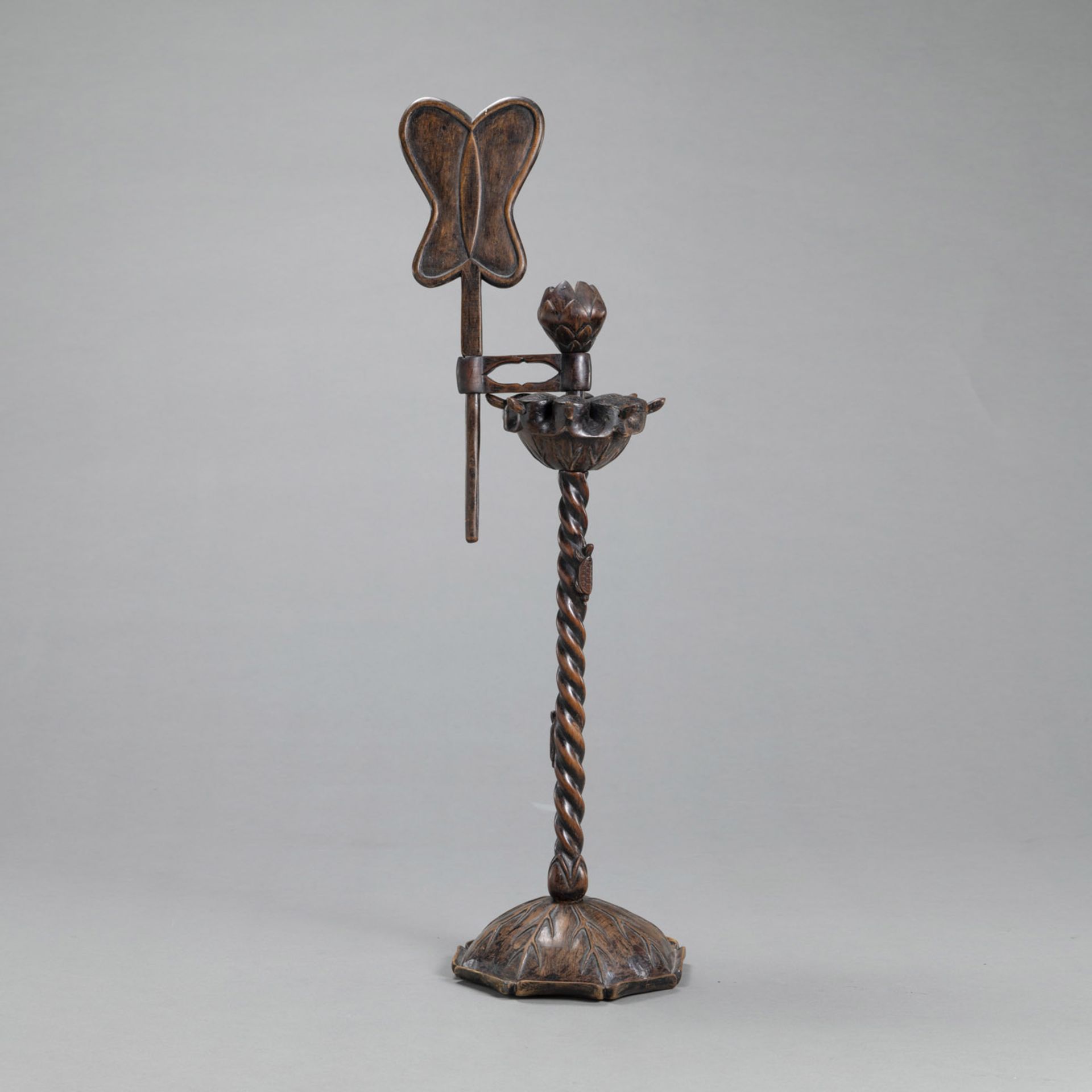 A MULTI-PART WOODEN CANDLESTICK  IN THE SHAPE OF A LOTUS DECORATED WITH SMALL TURTLES AND A LEAF FA