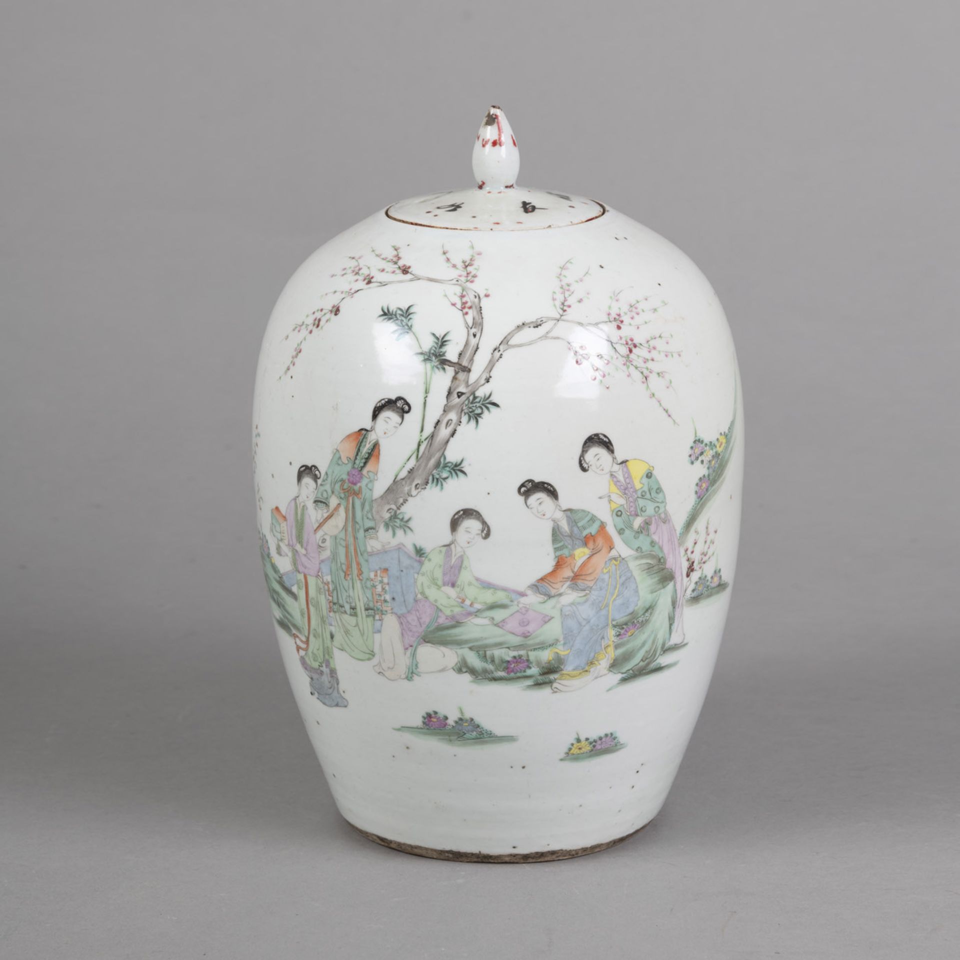 A POLYCHROME PAINTED PORCELAIN VASE AND COVER DEPICTING LADIES IN A GARDEN, ON THE RESERVE AN INSCR