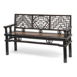 A PARTLY BLACK LACQUERED WOODEN BENCH, CARVED IN OPENWORK WITH GEOMETRIC AND RINGS DECORATION, SEAT