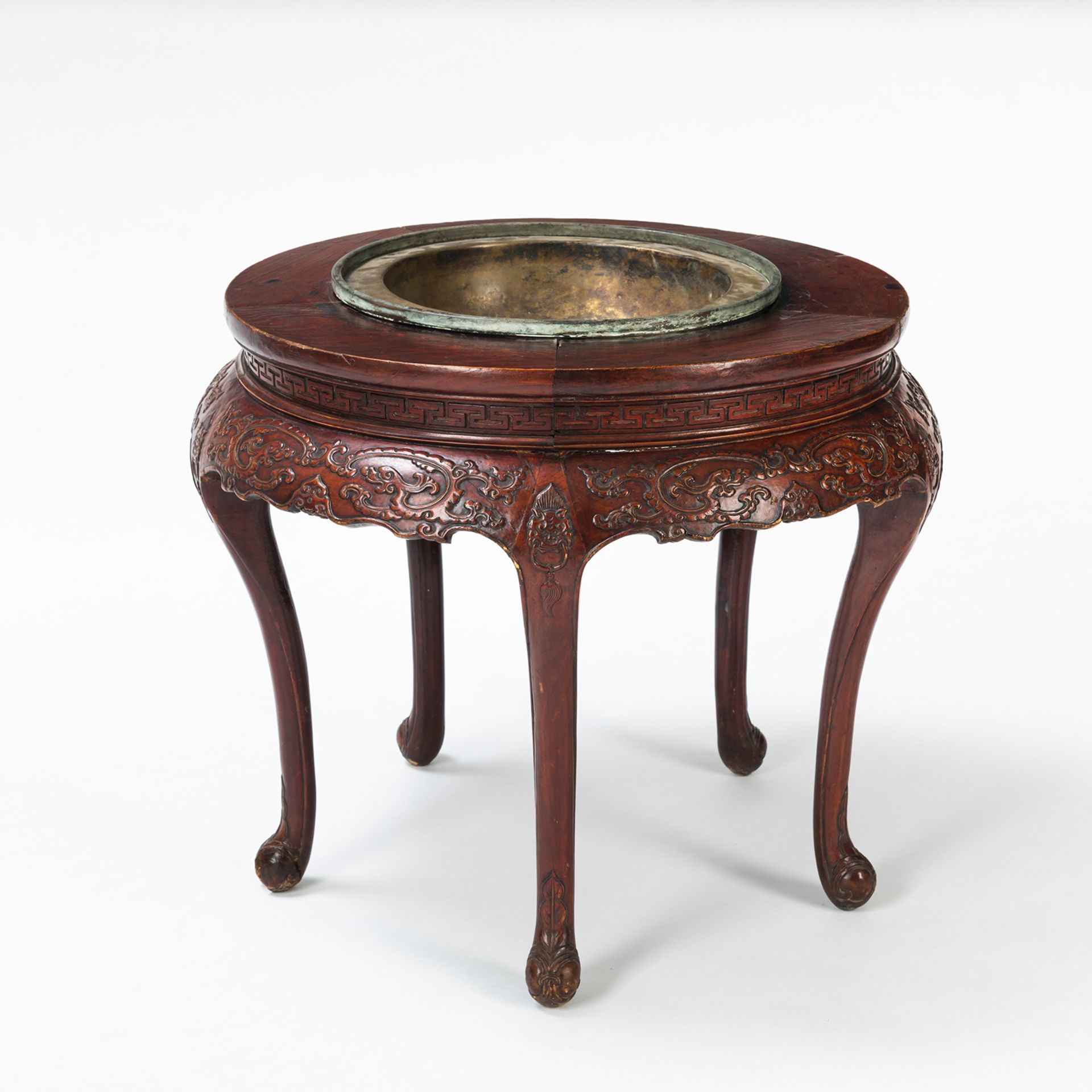 A CIRCULAR DRAGON RELIEF WOOD TABLE WITH METAL BASIN