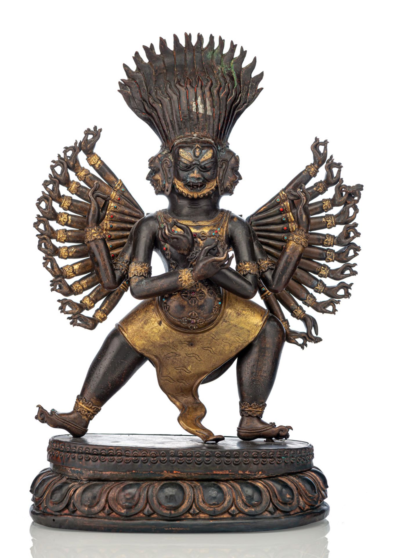AN EMBOSSED PARCEL-GILT COPPER TANTRIC DIVINITY