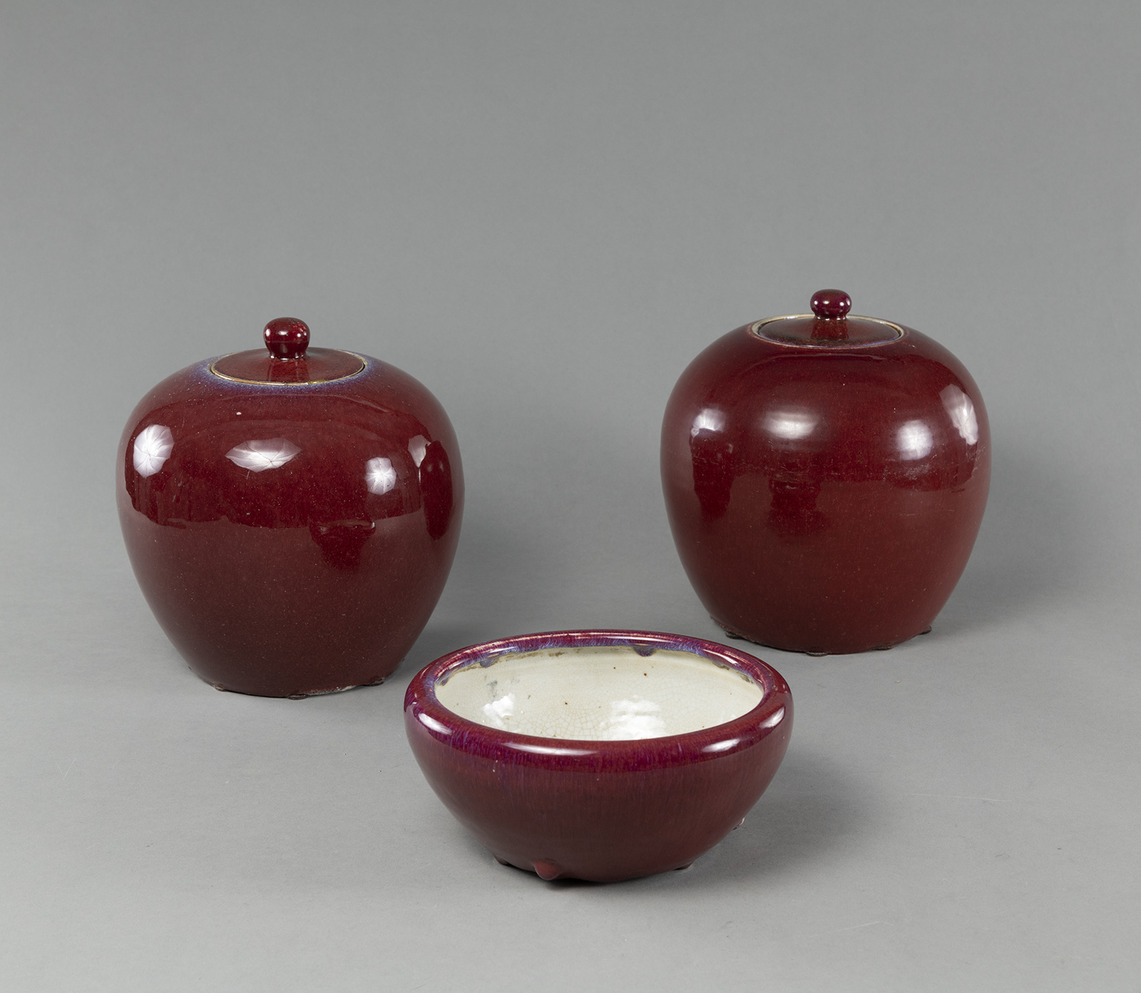 TWO OXBLOOD-GLAZED GINGER JARS AND A BRUSH WASHER
