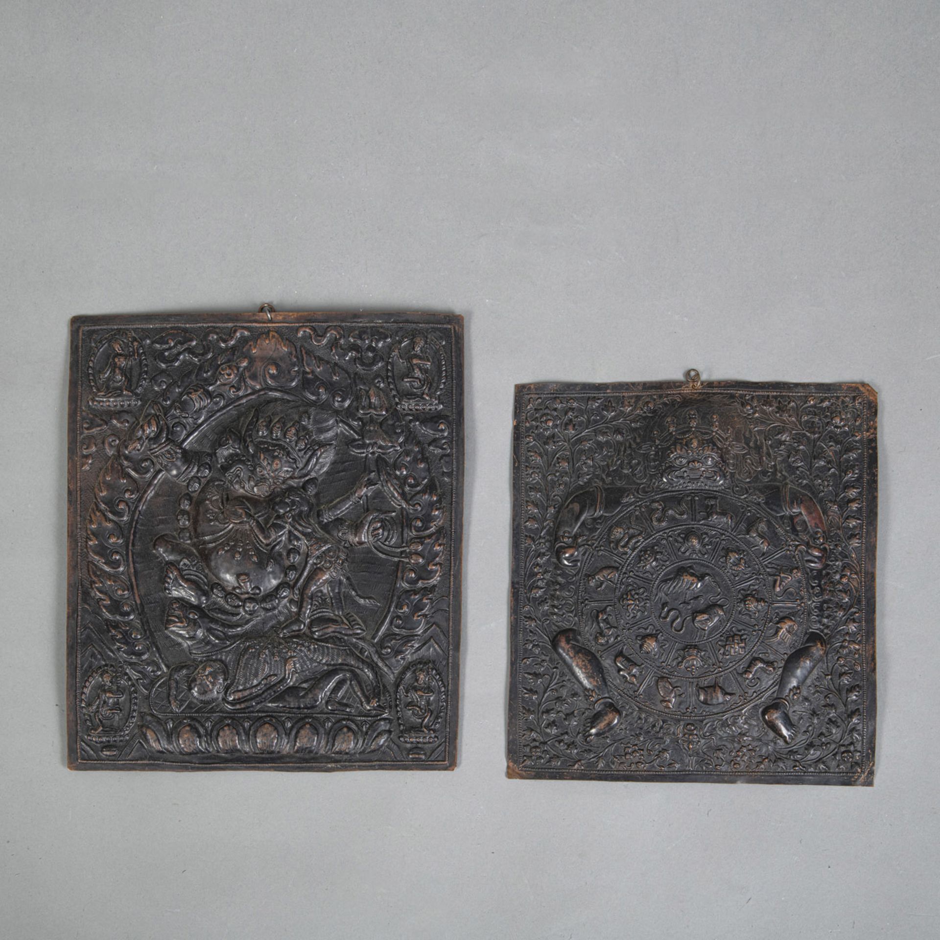 TWO EMBOSSED COPPER RECTANGULAR PLAQUES DEPICTING YAMA AND THE WHEEL OF LIFE