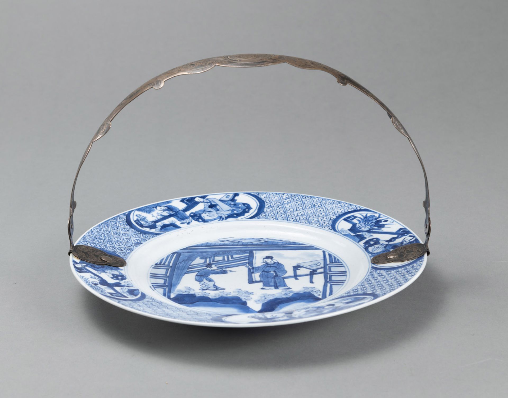 A BLUE AND WHITE DISH WITH FIGURAL DECORATION AND A LATER MOUNTED EUROPEAN SILVER HANDLE