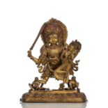 A LARGE AND MASSIVE GILT-BRONZE GROUP OF BHAIRAVA