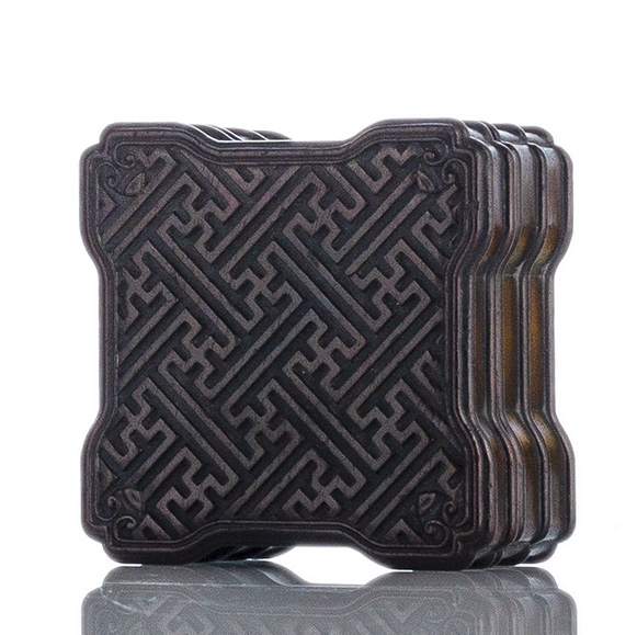 A QUADRILOBBED WOODEN BOX AND COVER WITH SWASTIKA MEANDER