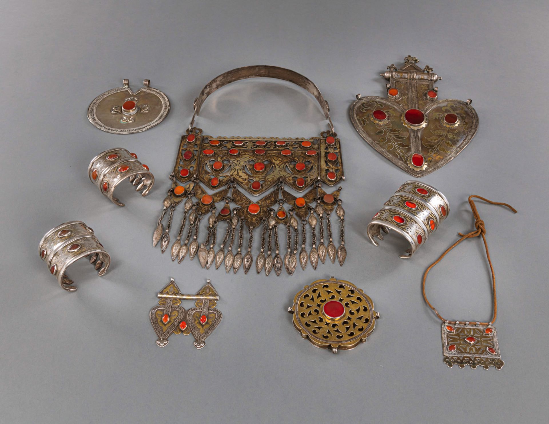 A GROUP OF NINE PIECES OF JEWELRY, INCLUDING BRACELETS, CHEST AND BACK ORNAMENTS, PARTIALLY GILDED 