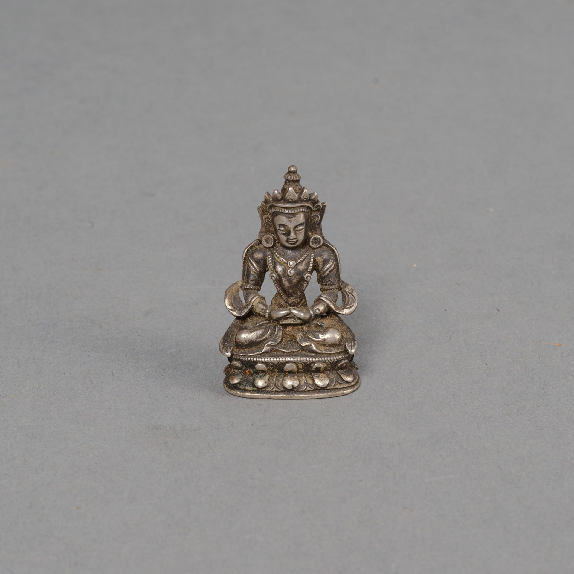 A MINIATURE BRONZE FIGURE OF AMITAYUS