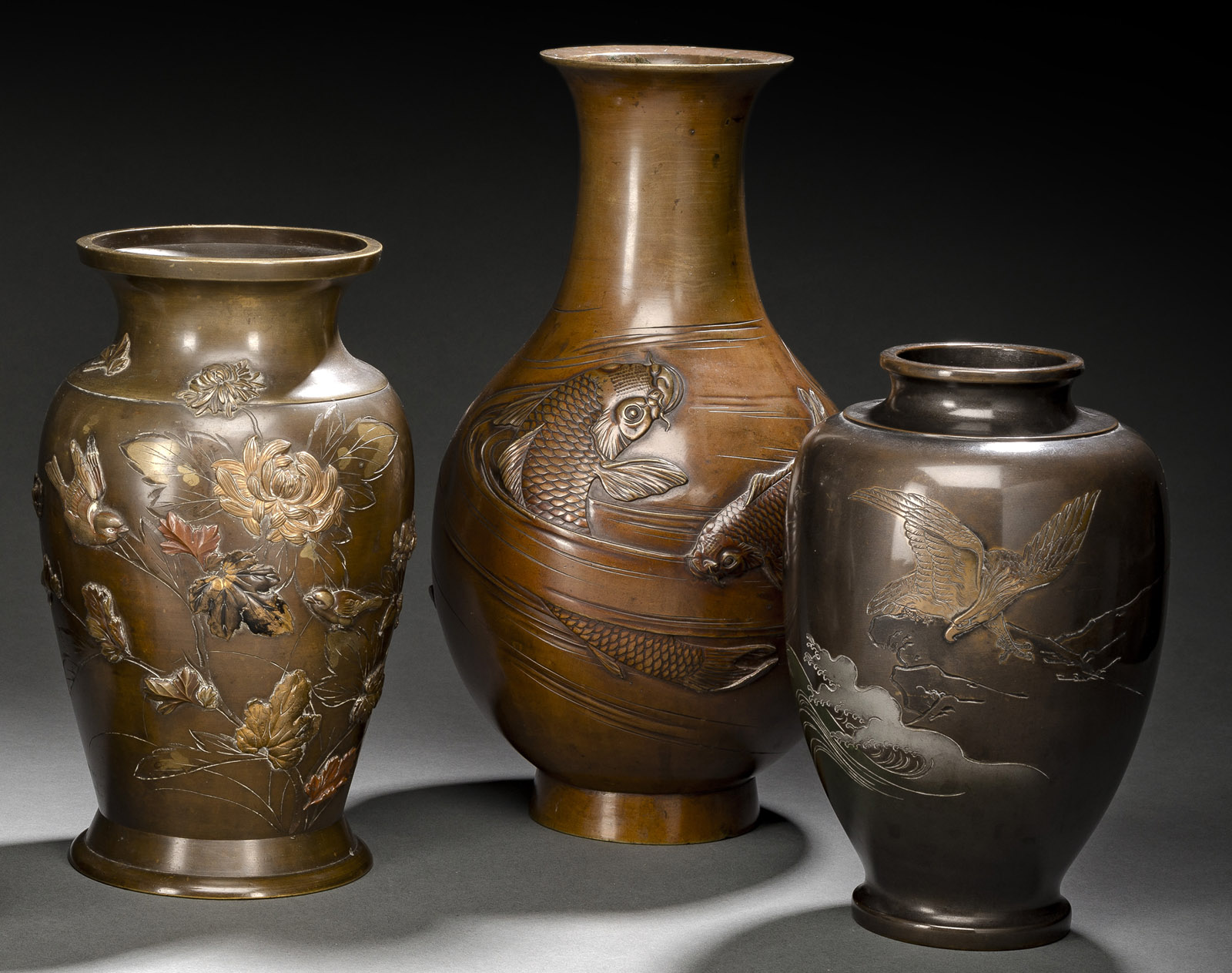 THREE BRONZE VASES AMONG OTHERS DECORATED WITH SPARROWS, AN EAGLE AND CARPS