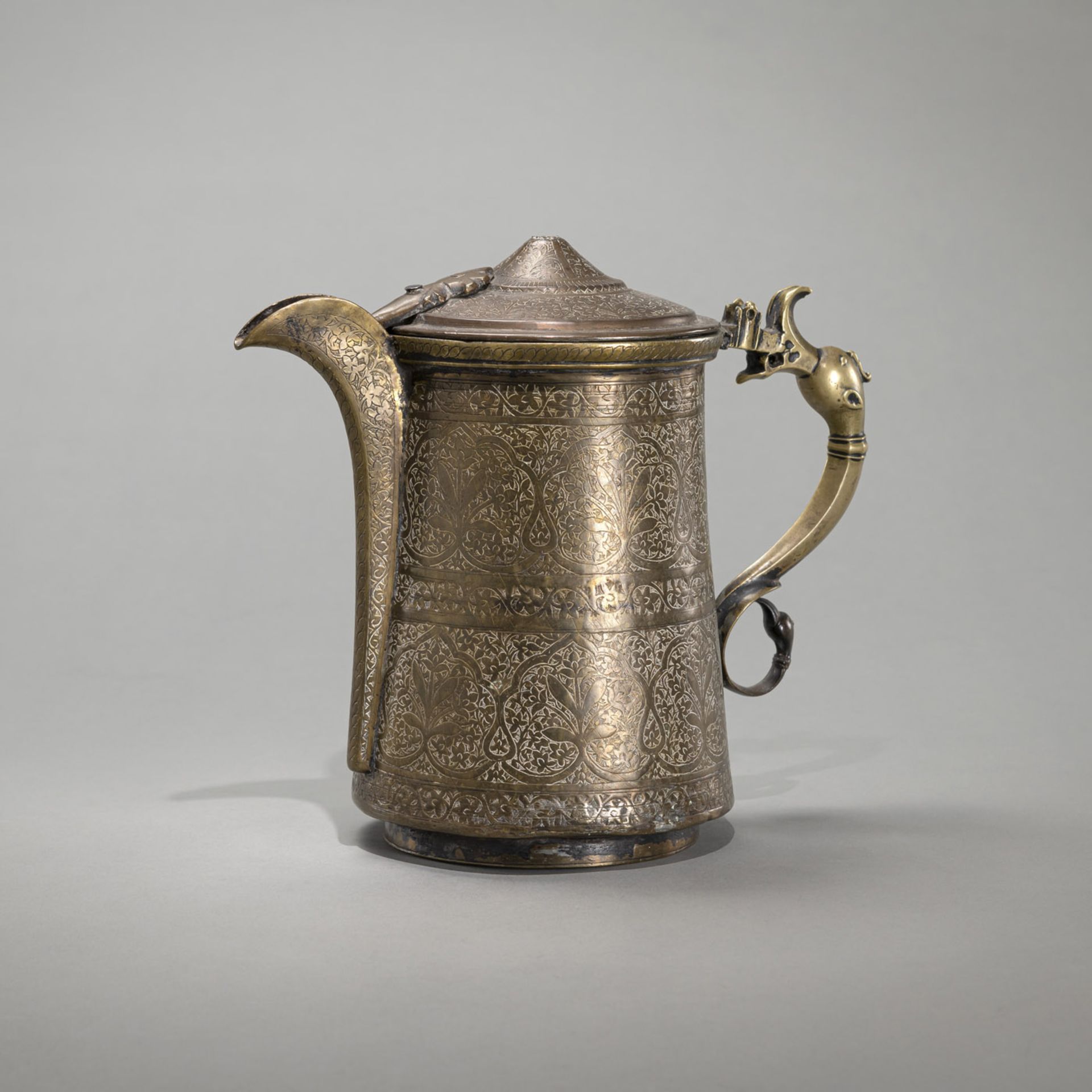 A FLORAL ENGRAVED LIDDED BRASS EWER