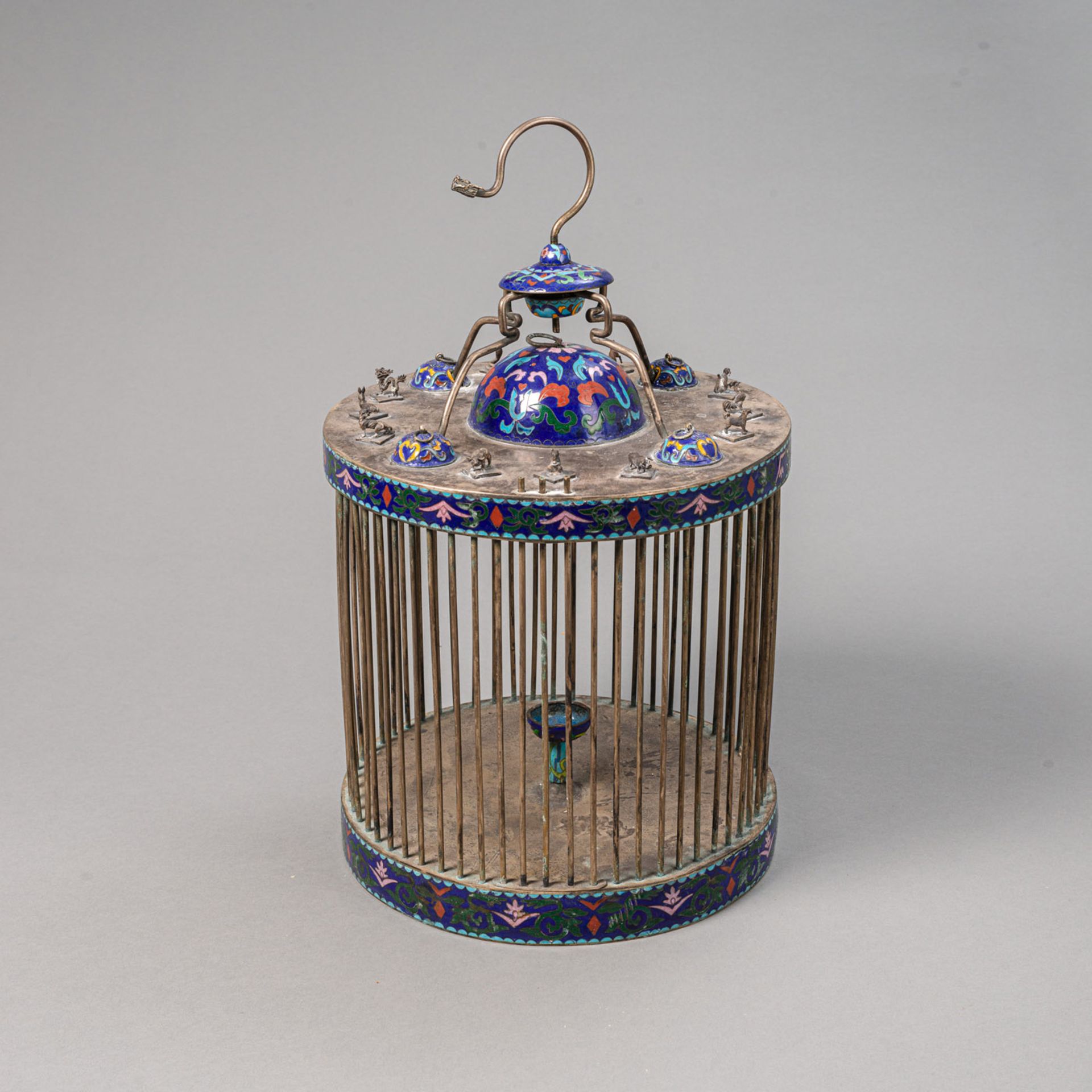 A SILVERED ENAMEL-DECORATED BIRD CAGE