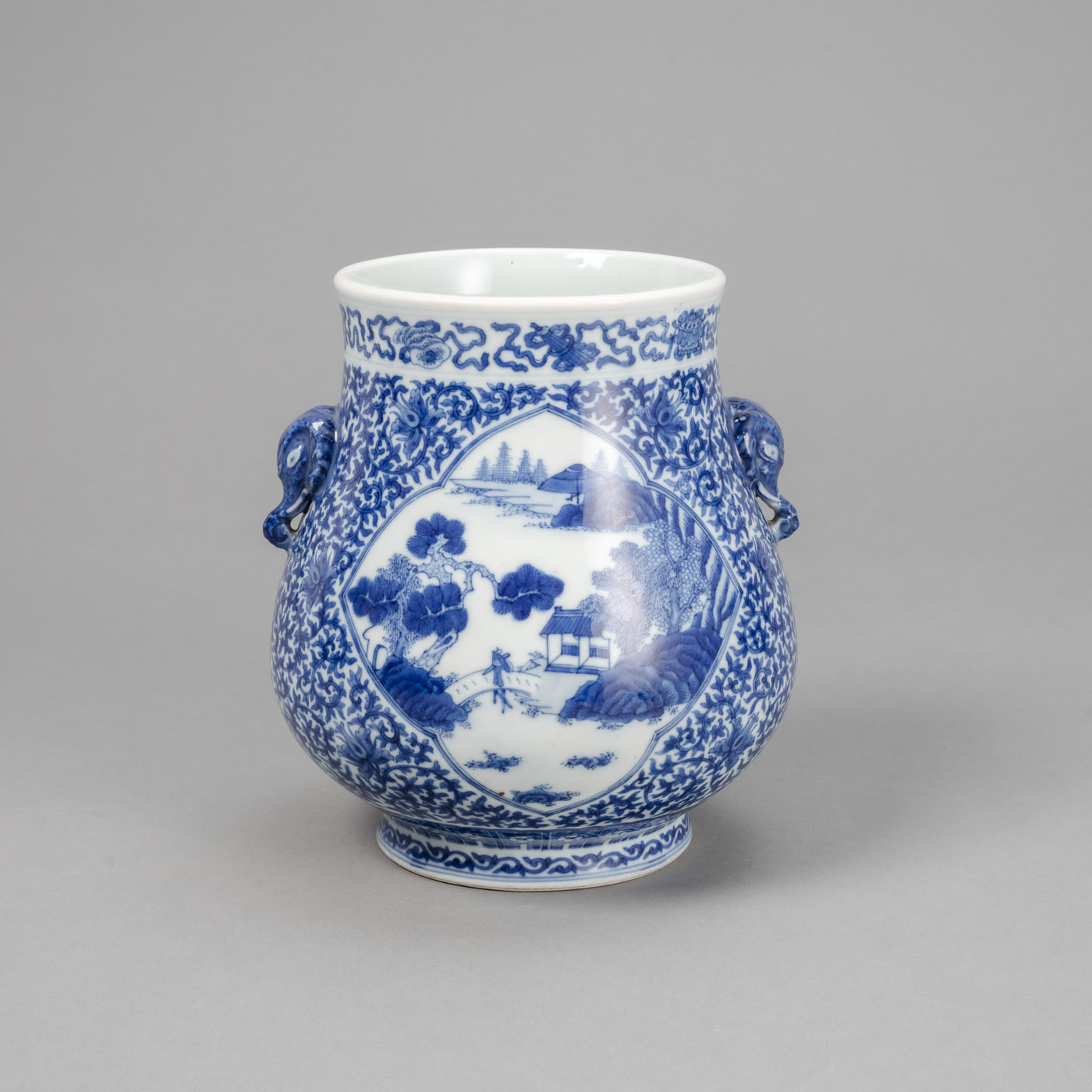 A 'HU'-SHAPED BLUE AND WHITE LOTUS PORCELAIN VASE WITH ELEPHANT-HEAD HANDLES