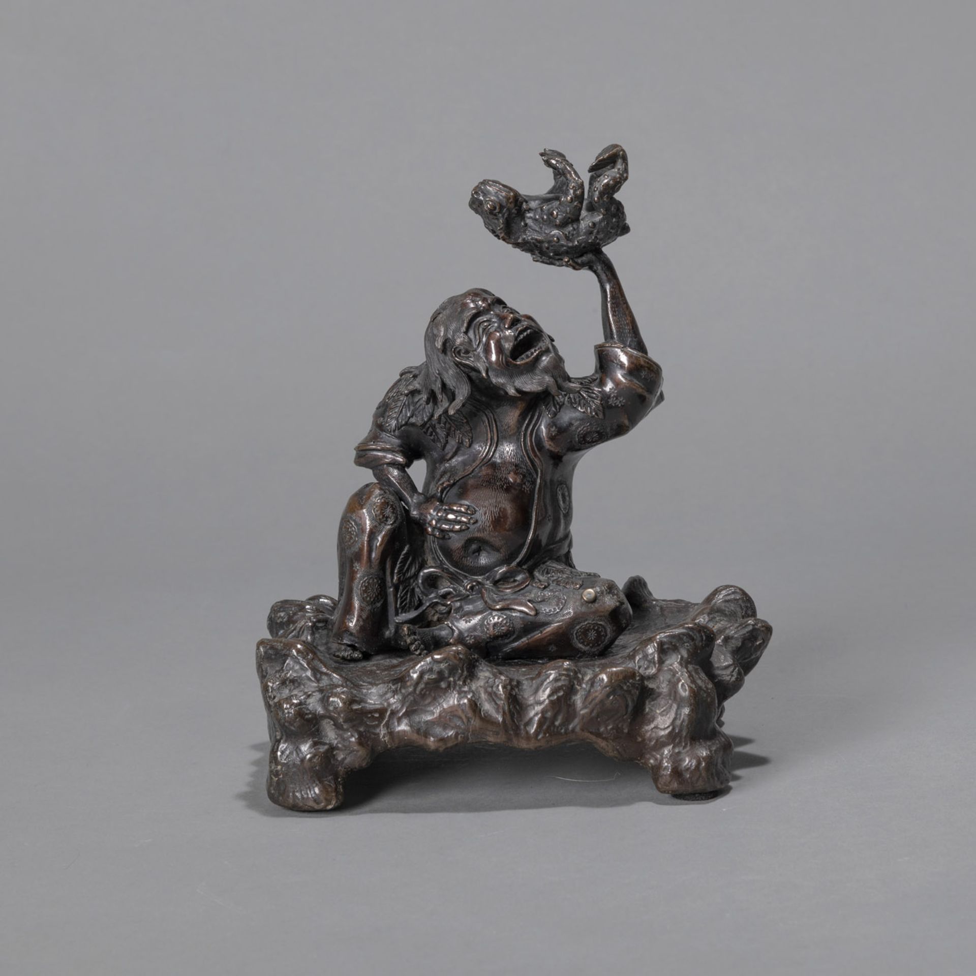 A BRONZE OKIMONO OF GAMA SENNIN HOLDING HIS TOAD