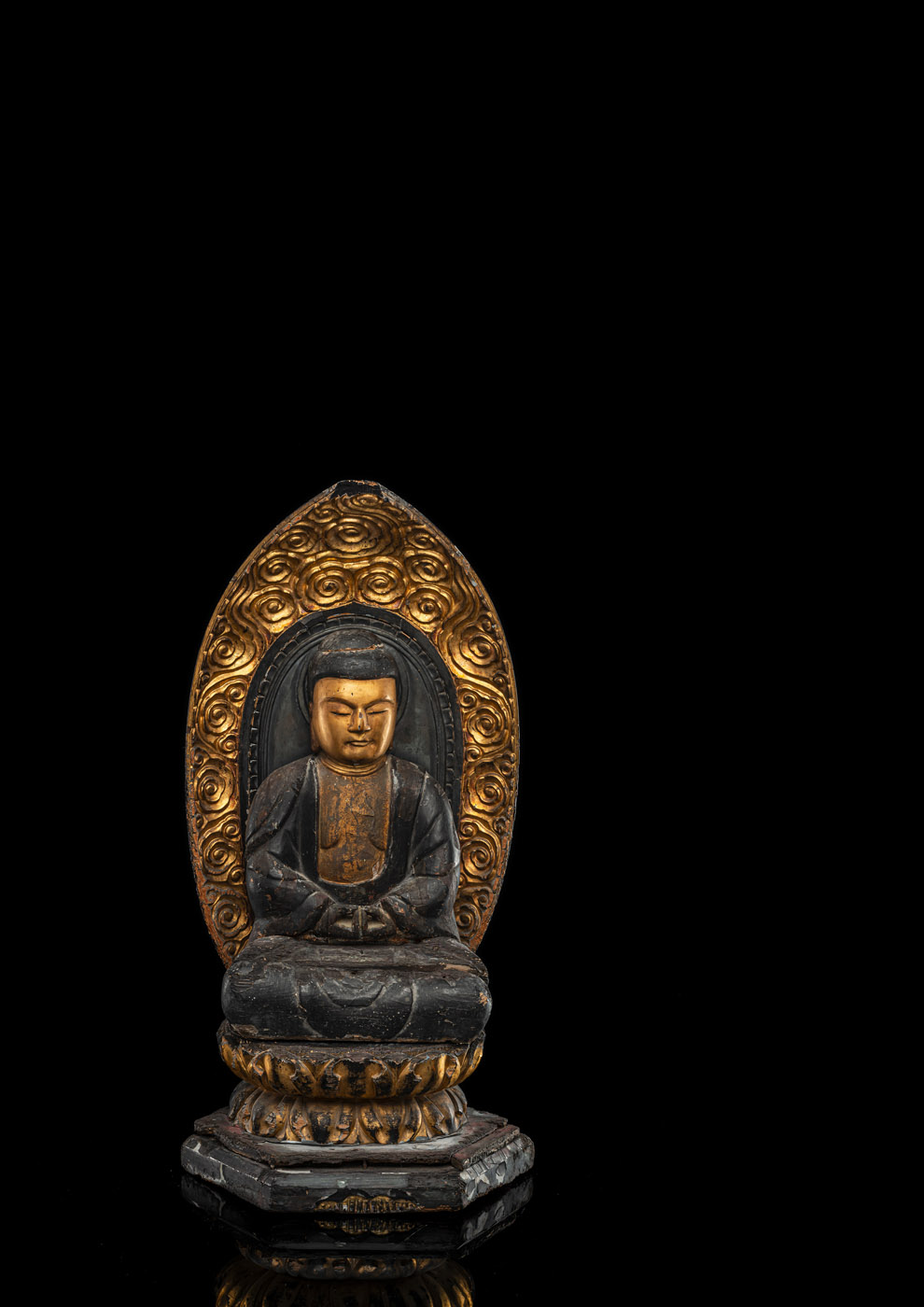 A PART-GILT CARVED WOODEN FIGURE OF SEATED BUDDHA