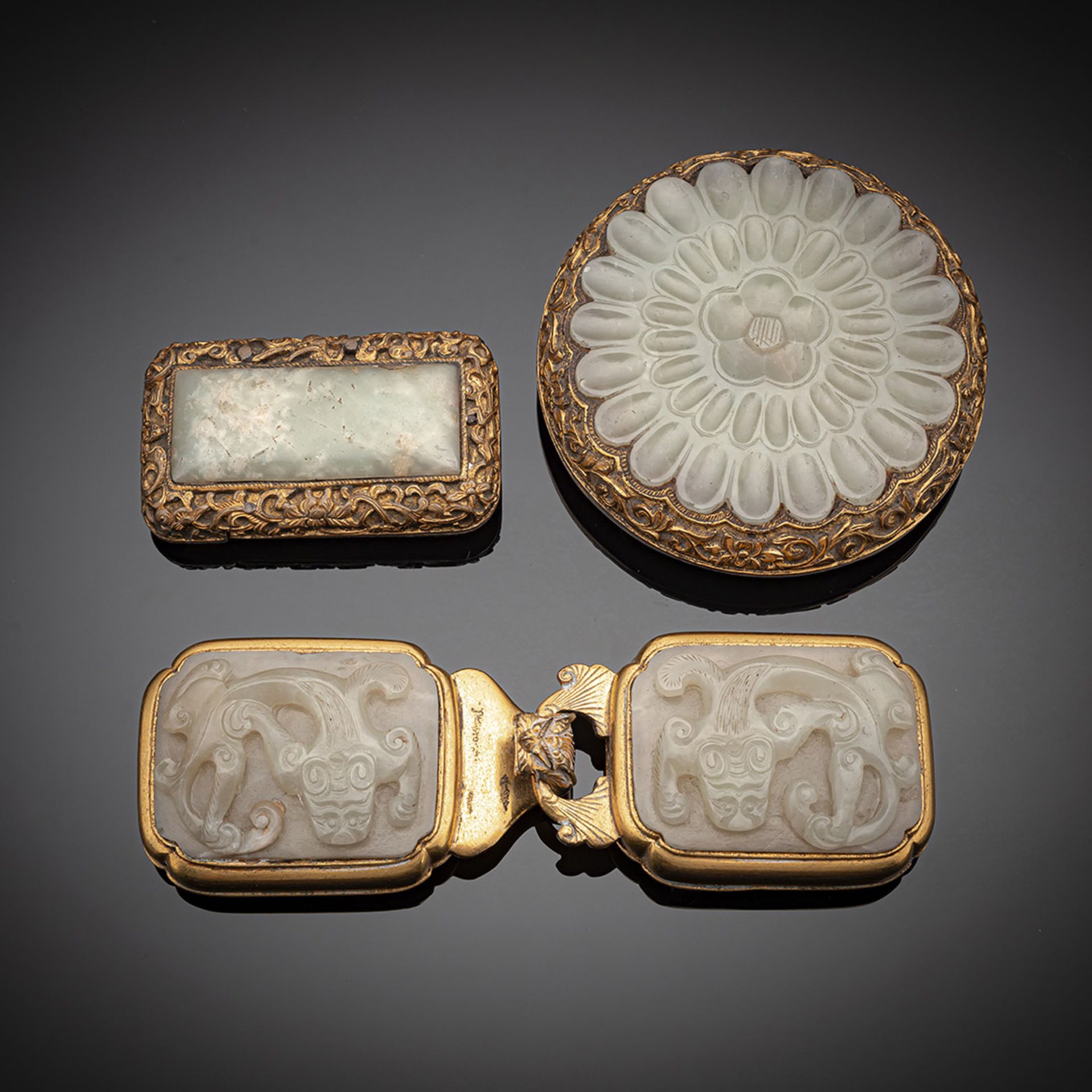 A GROUP OF THREE FINE GILT-BRONZE AND JADE-INLAID BELT BUCKLES