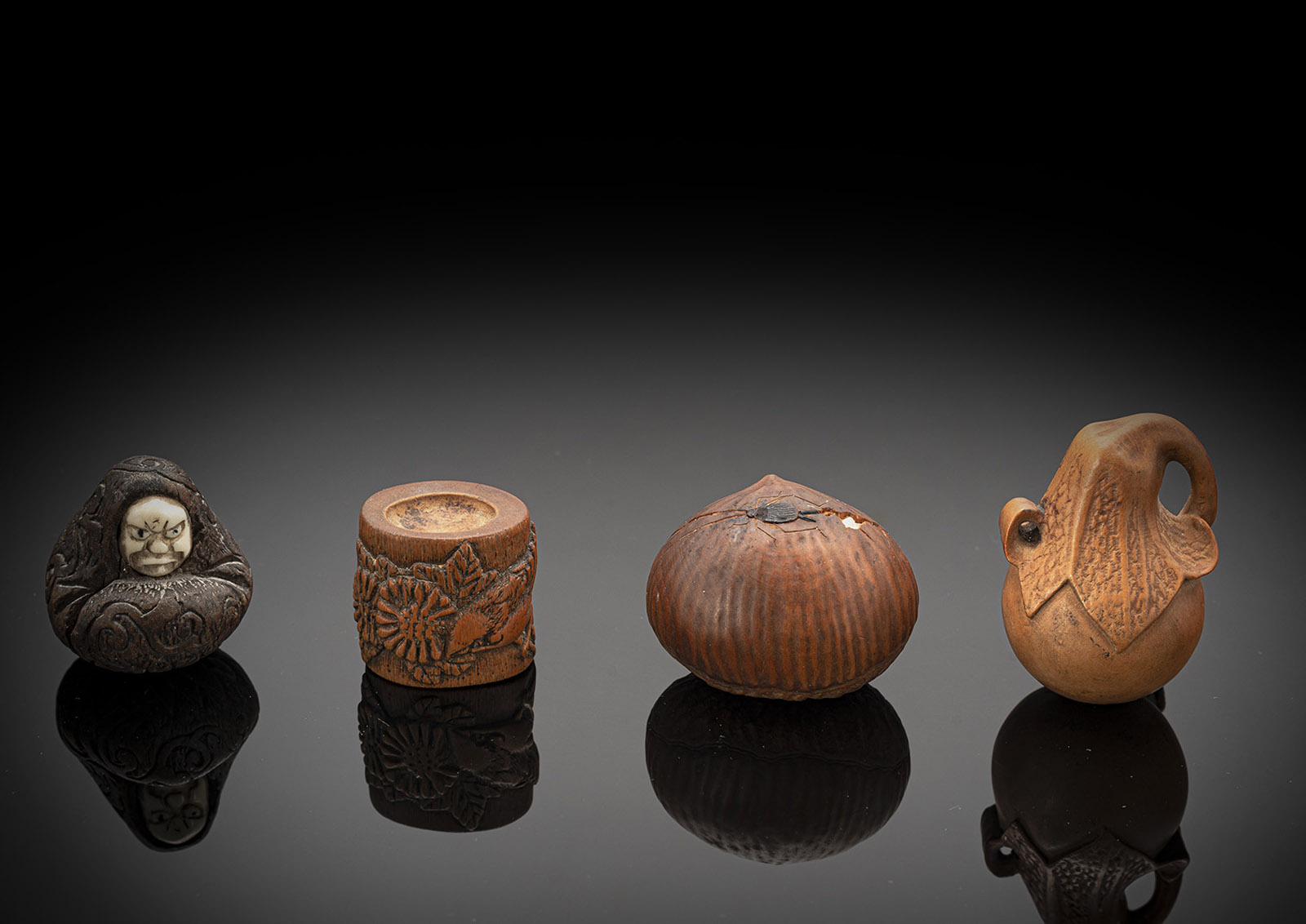 A GROUP OF FOUR WOOD NETSUKE