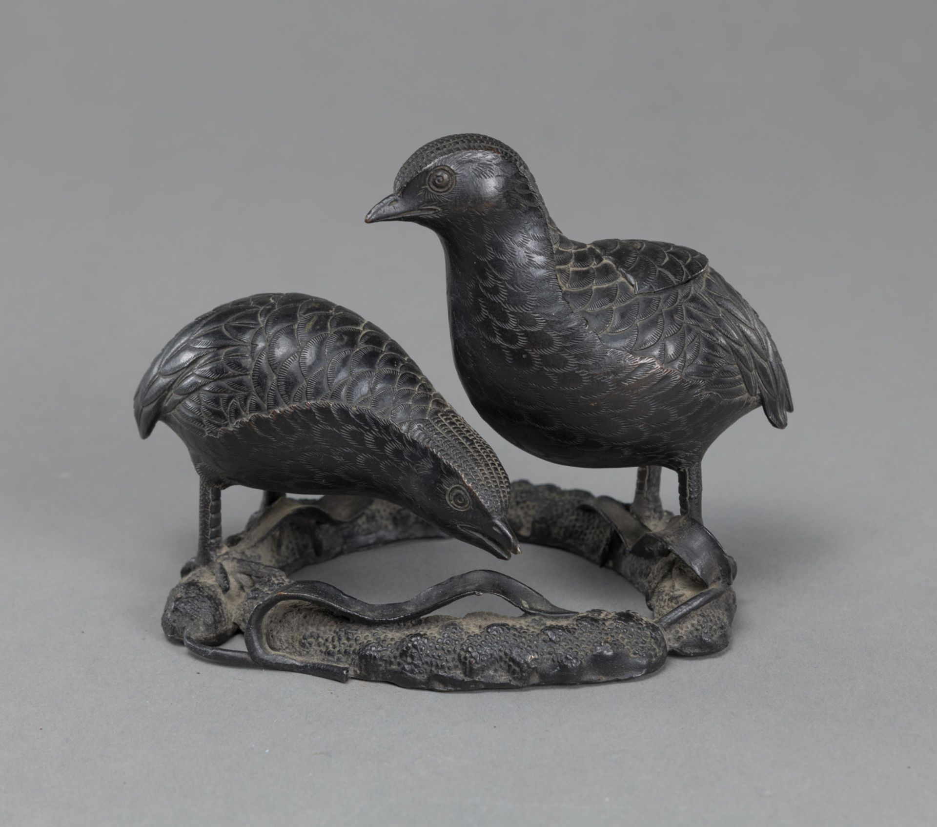 A BRONZE OKIMONO OF TWO QUAILS