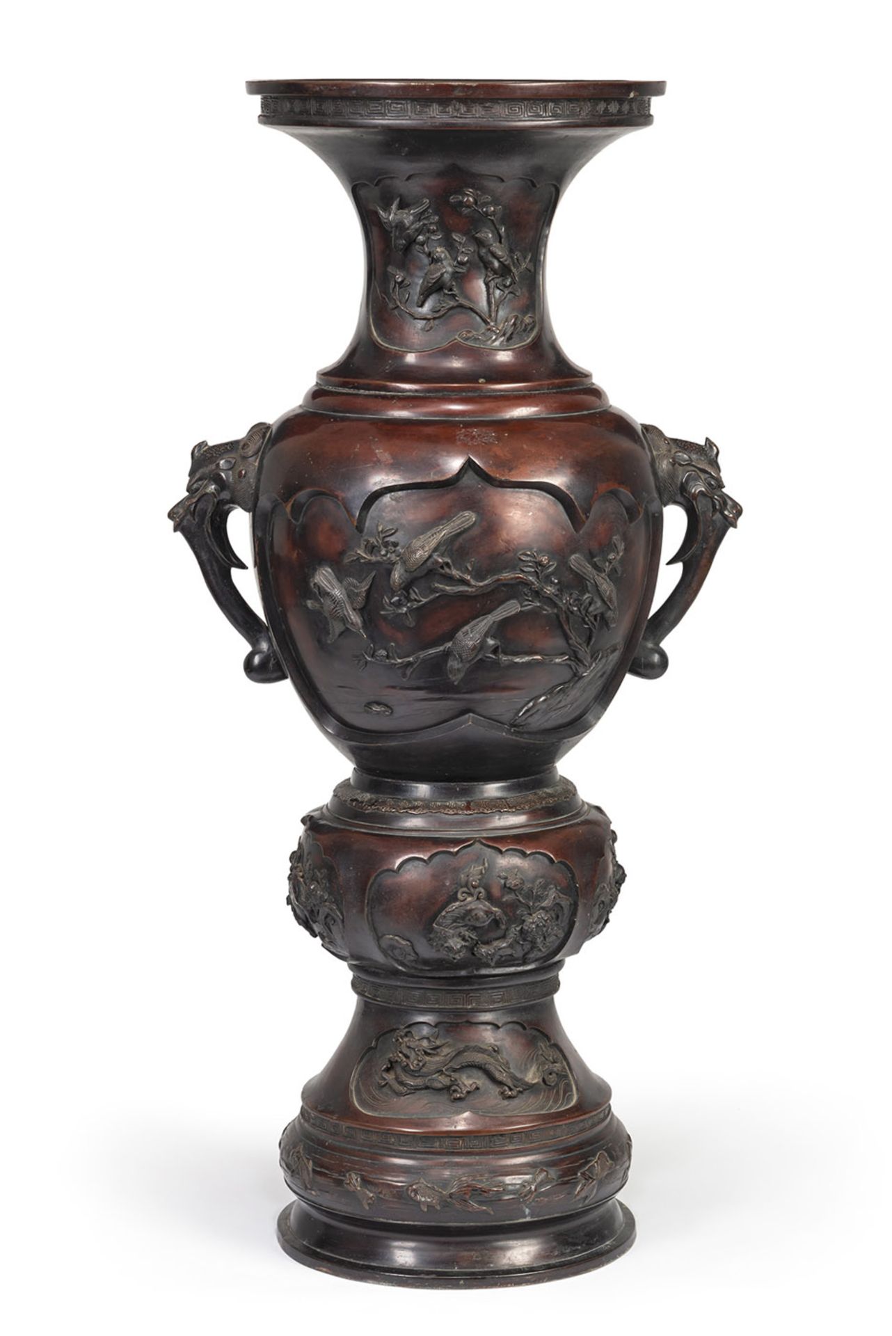 A LARGE BRONZE VASE WITH TWO BAKU HEAD HANDLES AND RESERVES DEPICTING FLOWERS AND BIRD IN RELIEF ON