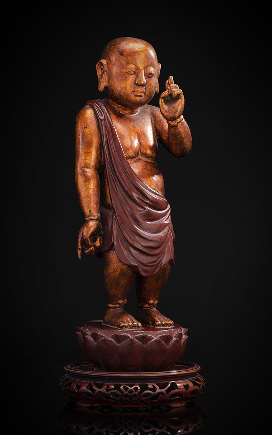 A GILT- AND RED-LACQUERED WOOD FIGURE OF THE INFANT BUDDHA