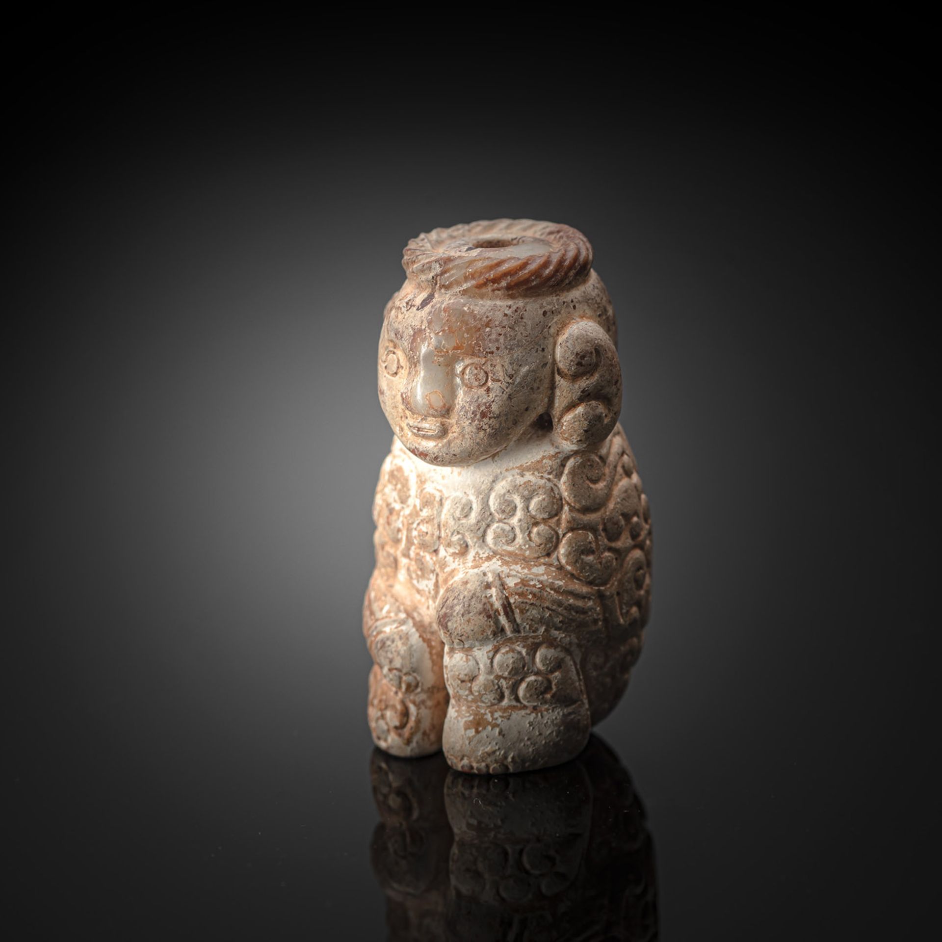 A FINE AND RARE CALCIFIED JADE FIGURE OF A SEATED MAN