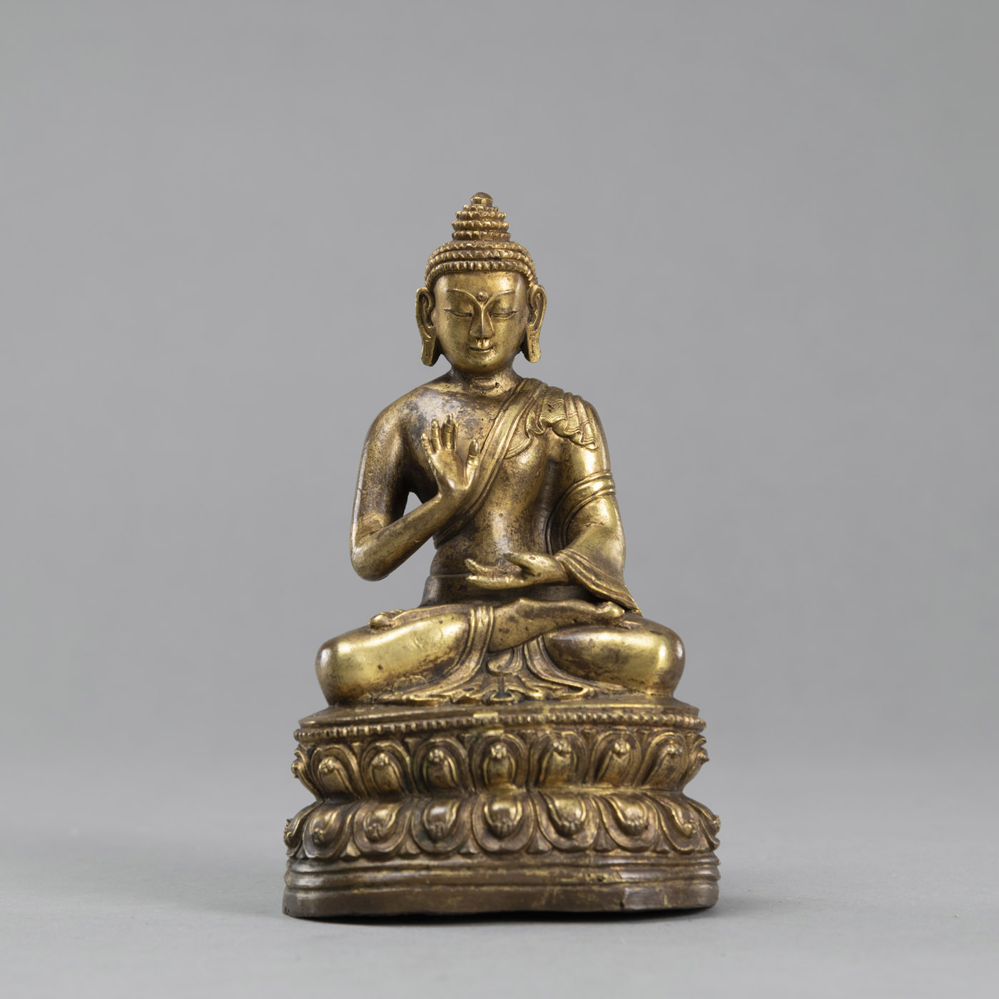 A SEATED BRONZE BUDDHA SHAKYAMUNI