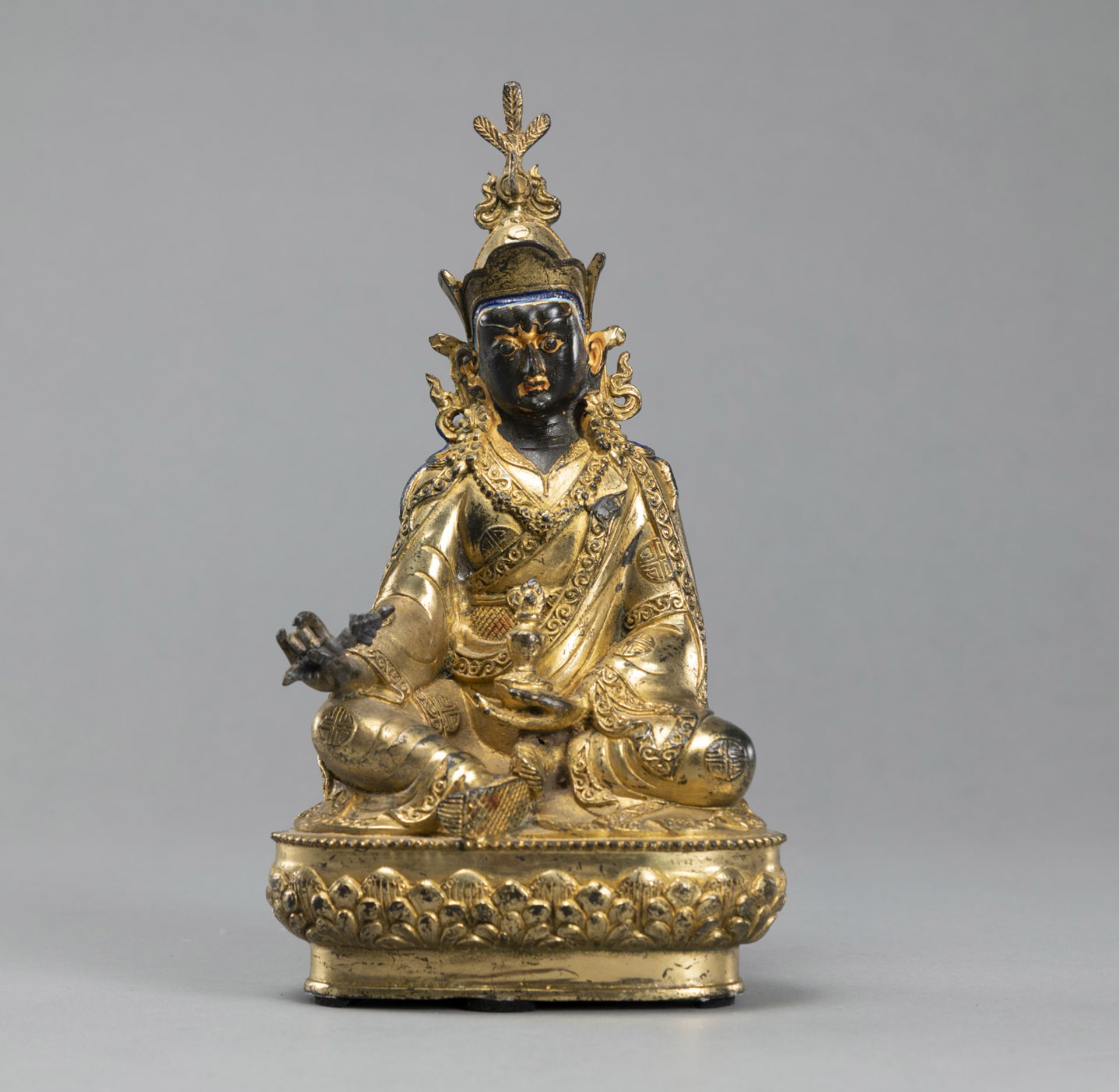 A PARCEL-GILT BRONZE FIGURE OF PADMASAMBHAVA