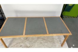 Wooden table, three square grey boxes within the d