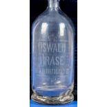 Antike Glasflasche, farbloses, dickwandiges Glas, frontal bez.: Oswald Brase Harburg a./E. Höhe ca.