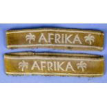 2 Ärmelbänder "AFRIKA", konfektionierter khakibrauner Stoff mit silbergrauer Kunstseide bestickt. G