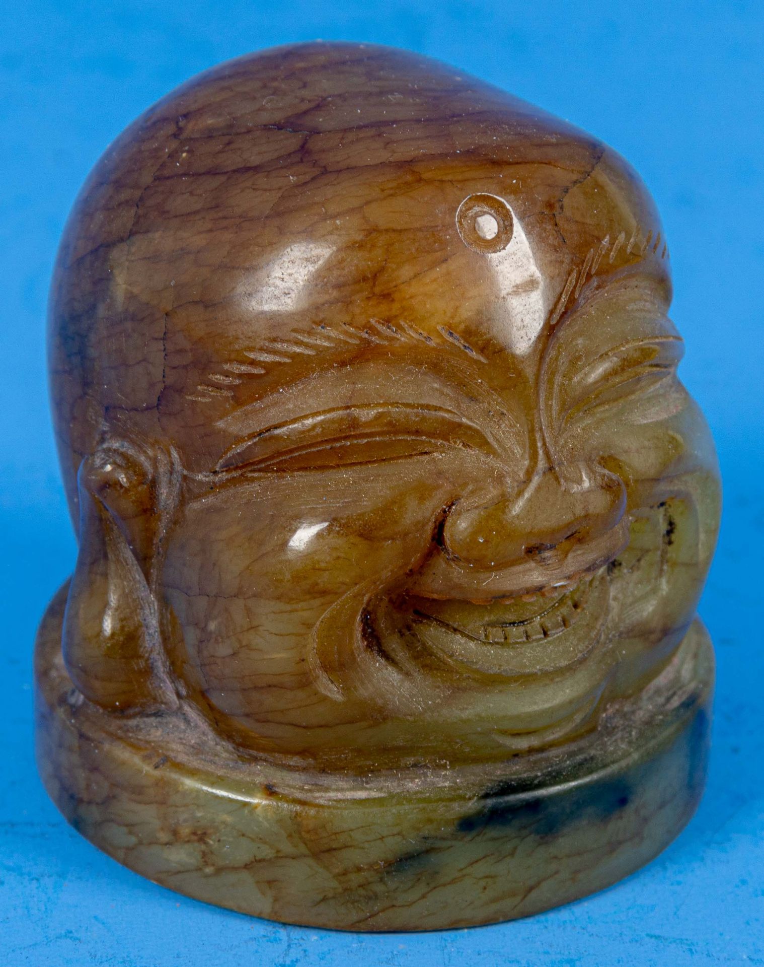 Briefbeschwerer bzw. Stempelrohling, grün-bräunliche Jade als "Lachender Buddha"-Kopf gearbeitet, o