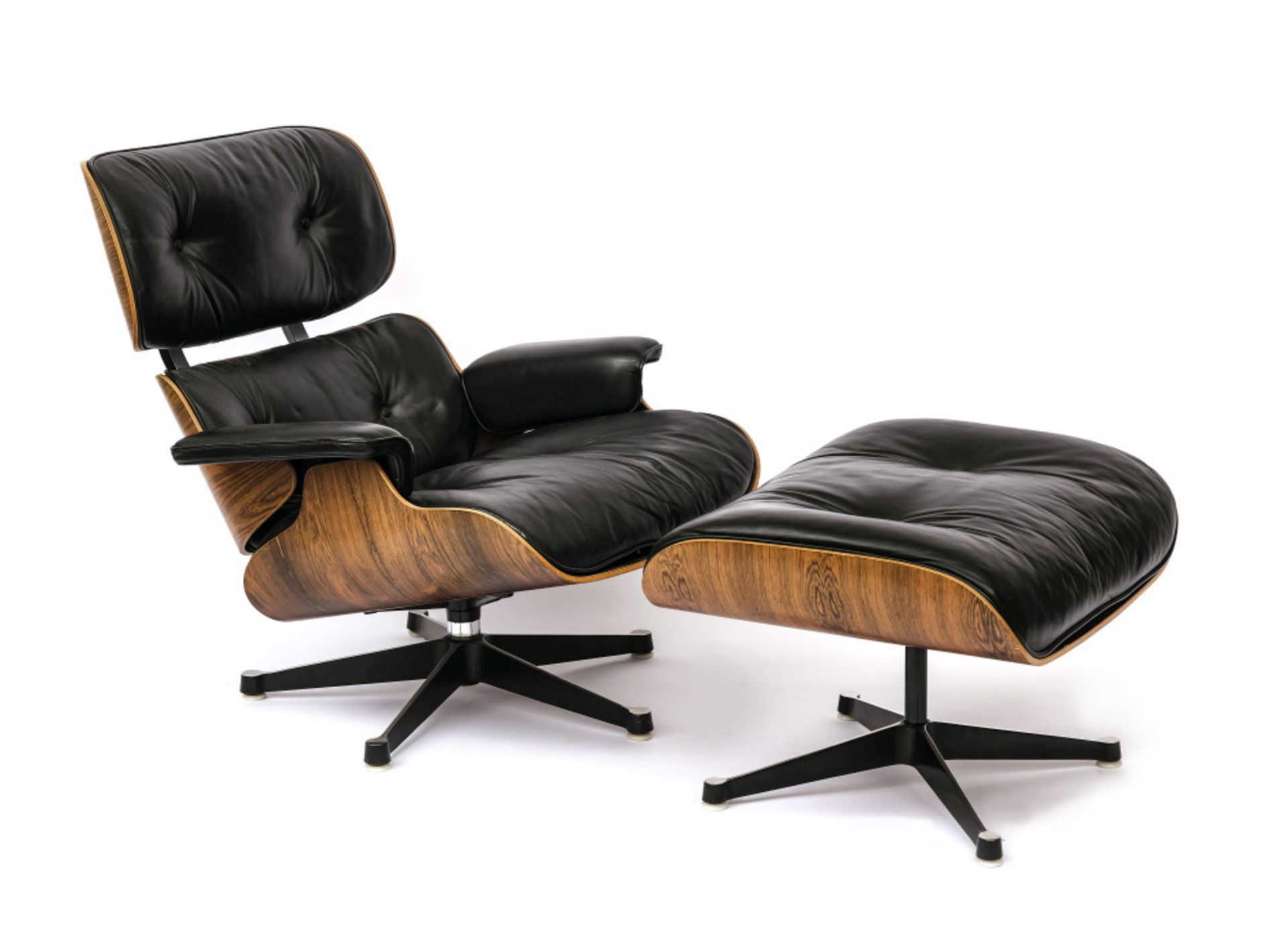 A lounge chair with ottoman - Design by Ray and Charles Eames for Vitra 