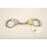 A set of Hiatts stainless steel juvenile handcuffs; 26cm long Reserve: £20 #1247