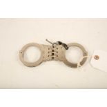 A pair of Hiatt stainless handcuffs; 18cm long; complete with key Reserve: £40 #1245