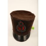 An early 20th century black velvet peak cap; applied Royal Irish Constabulary King's Crown plaque;