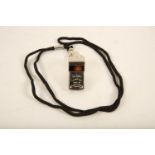 An Acme 'Thunderer' stainless steel Policeman's whistle on black cord; whistle length 45mm