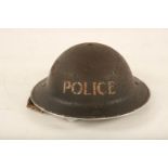 A mid 20th century painted tin Policeman's helmet; 31cm diameter Reserve: £25 #1186