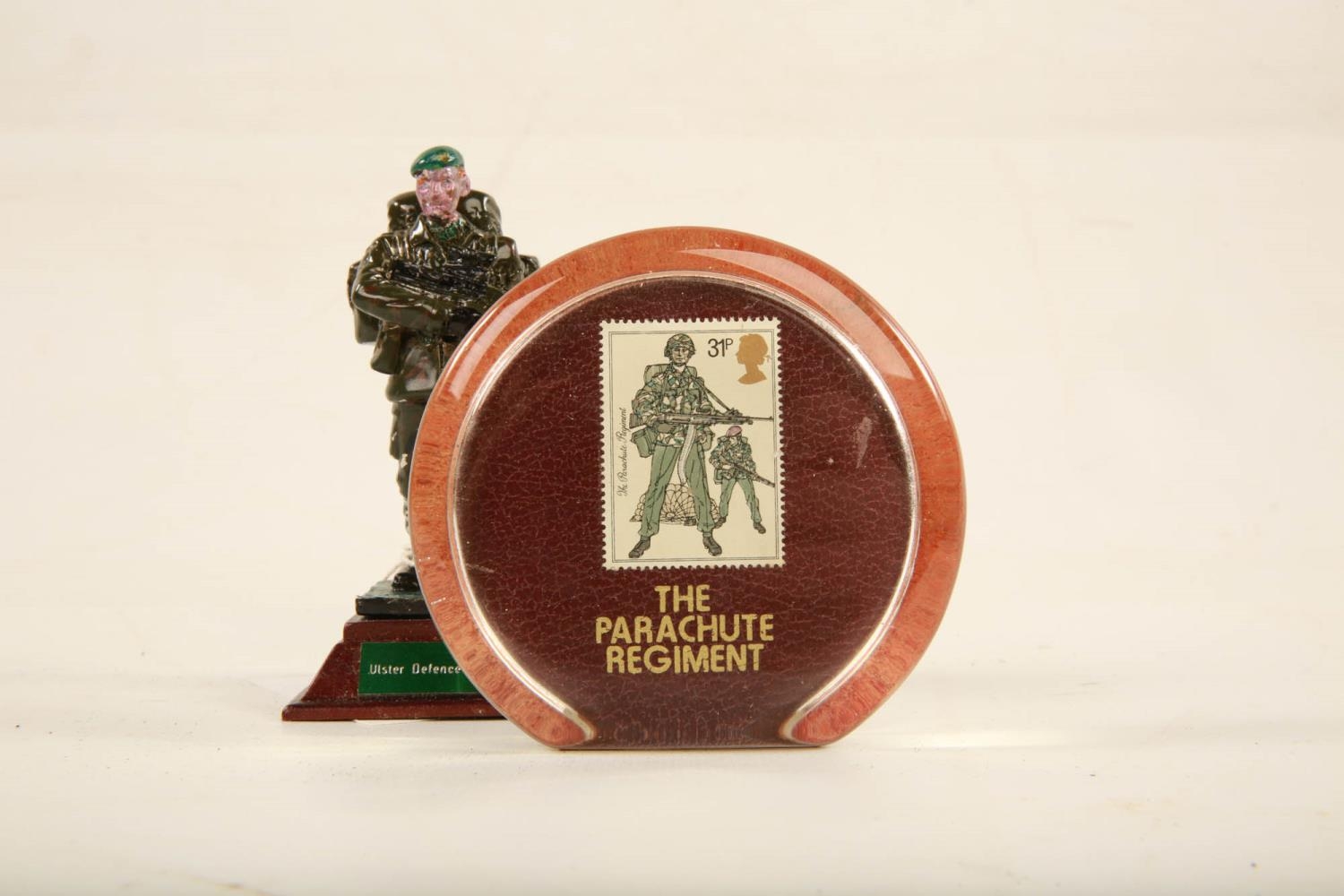 A painted lead model of an Ulster Defence Regiment soldier raised on square wooden plinth; 11cm high