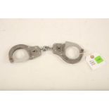 A pair of Chubb stainless steel handcuffs; 28cm long Reserve: £30 #1248