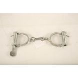 A set of reproduction steel handcuffs; 25cm long #1230